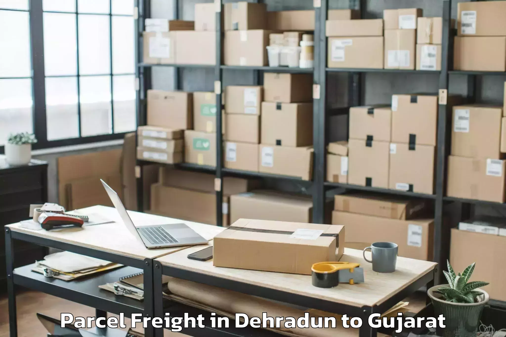 Book Dehradun to Malpur Parcel Freight